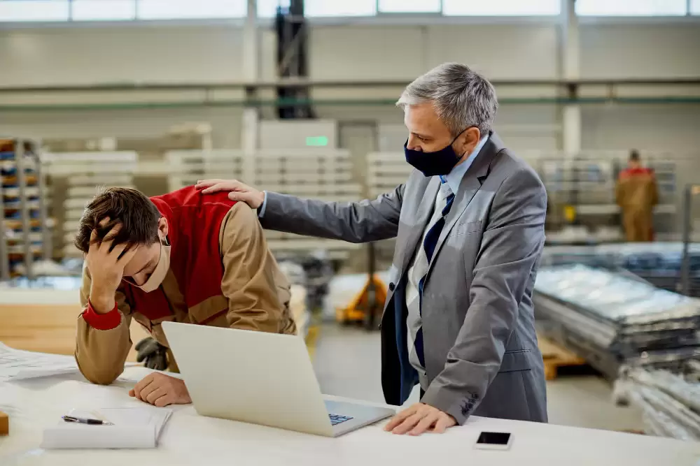 Two men wearing face masks at work