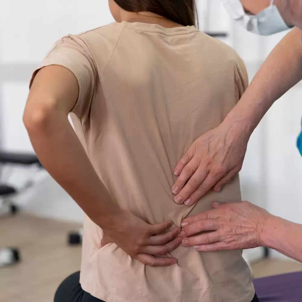Woman receiving physiotherapy from a specialist.