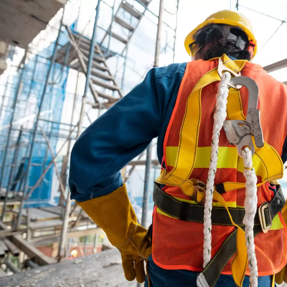 A worker wearing a safety harness