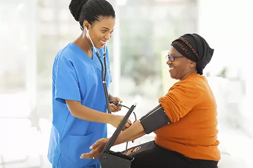 Occupational health specialist taking a woman's blood pressure