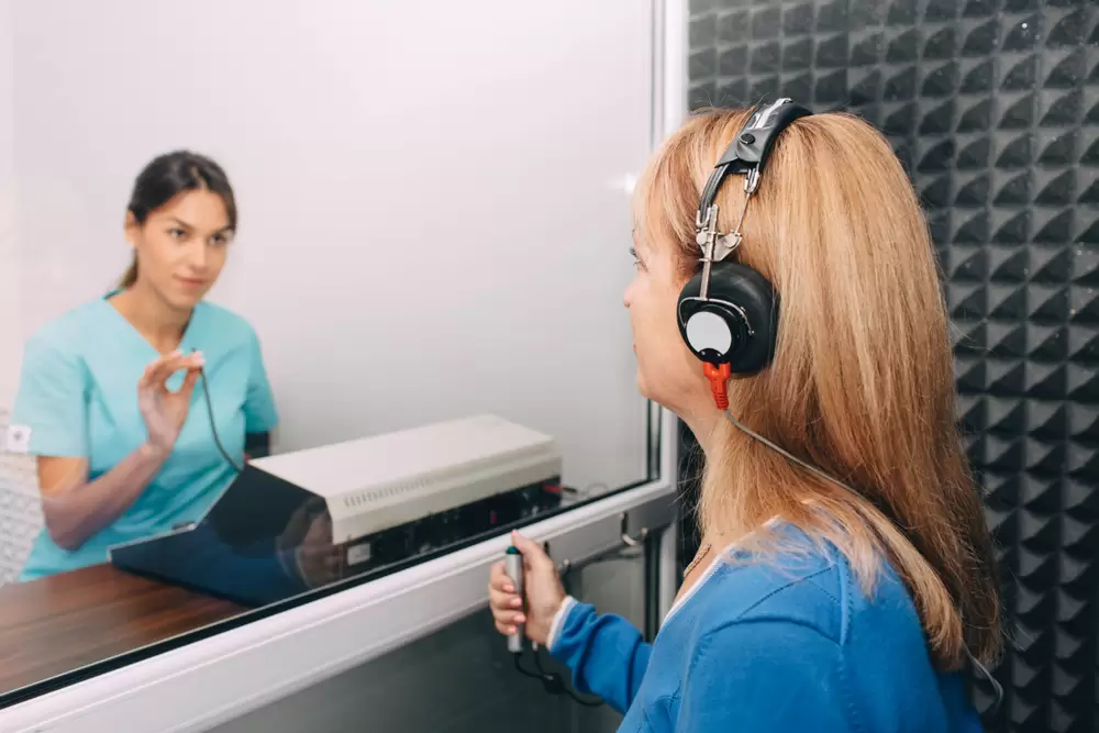 Occupational health professional administering a hearing test