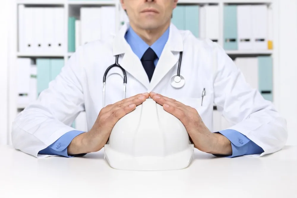 Occupational health professional holding a hard hat
