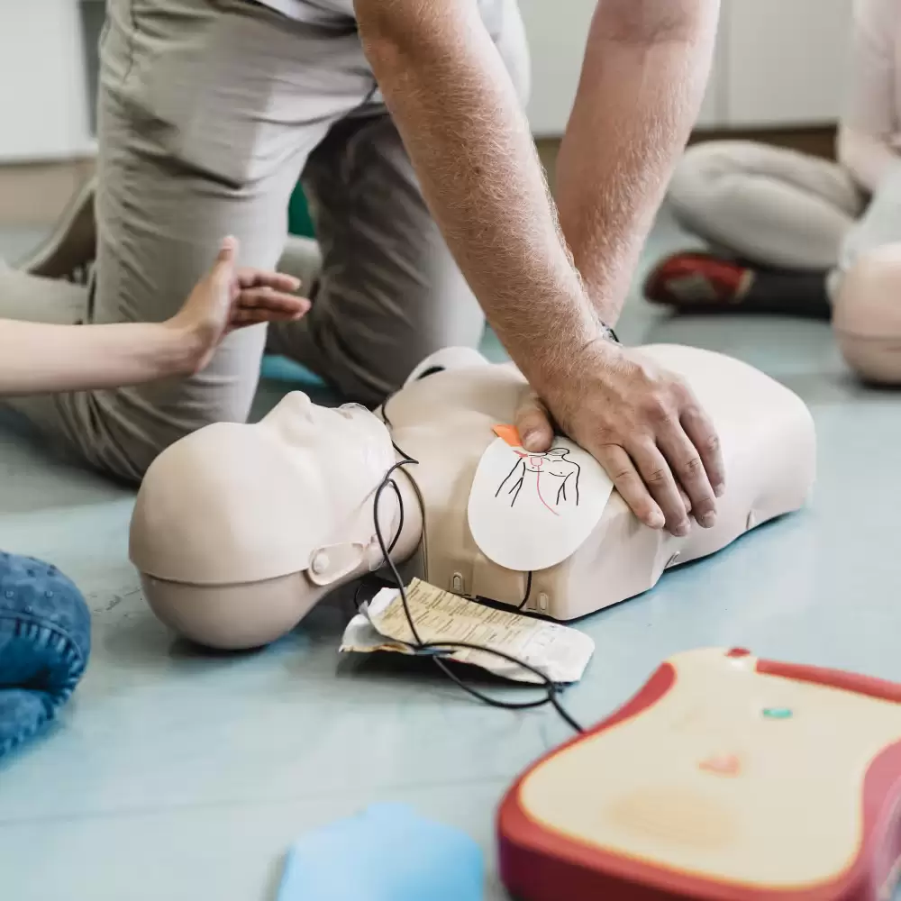 Person performing CPR on a dummy